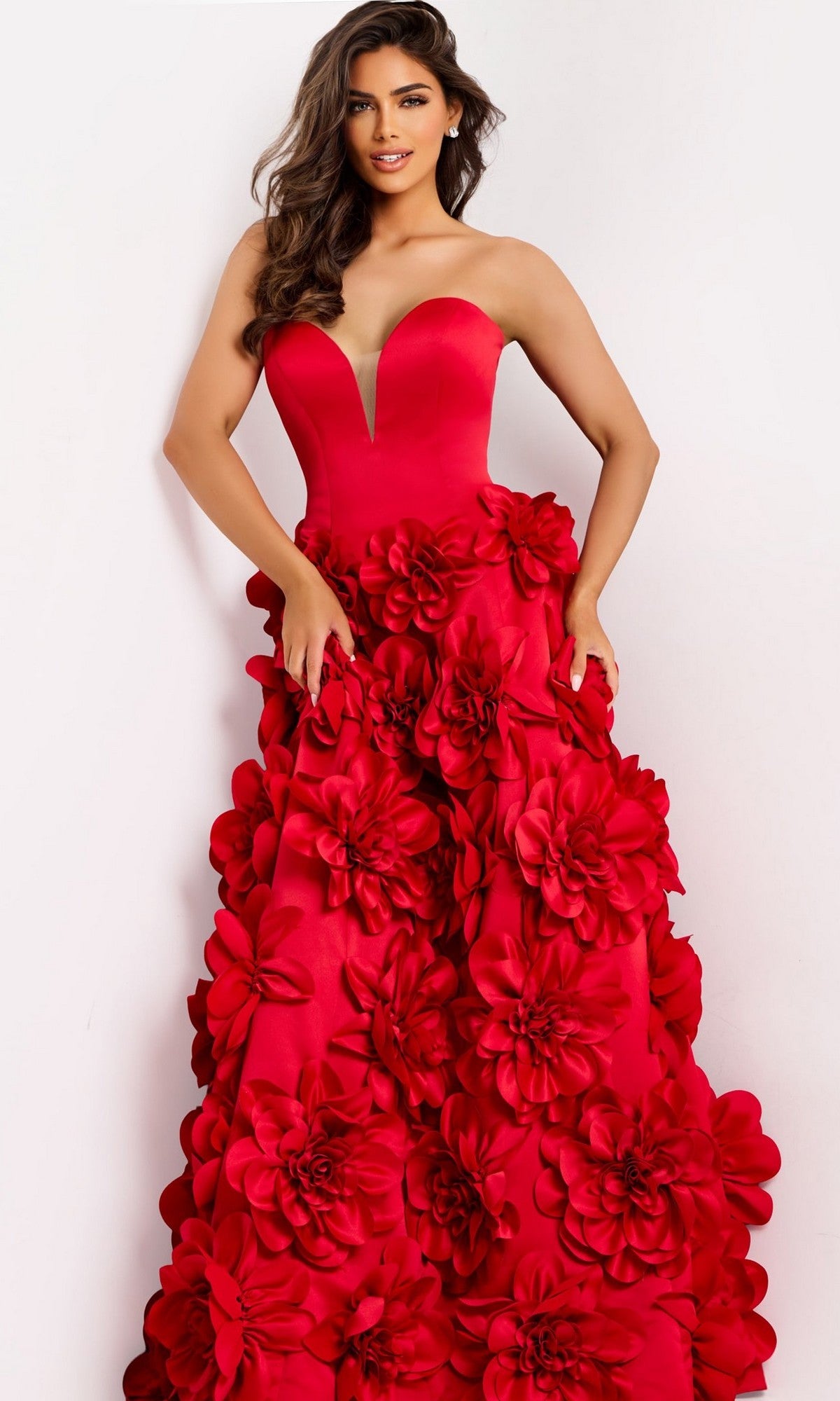 A woman wearing the Jovani 45661 long prom dress, featuring a strapless sweetheart neckline and bold 3D floral appliques, stands against a plain background.